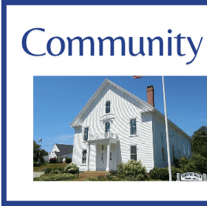 a white historic building with a porch and a chimney, labeled with the word “community” above it.